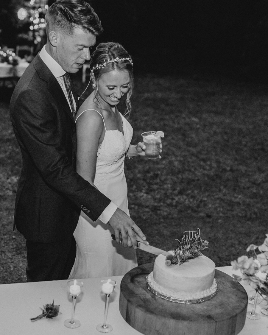bride and groom cut cake during wedding reception