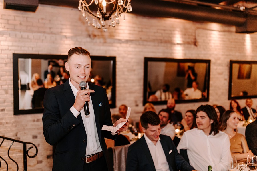 man giving wedding toast during reception