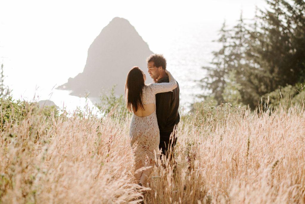 Nicole and Dawshawn gaze lovingly into each others eyes as they enjoy the sunset over Cape Ferello at this dreamy Oregon Coast engagement session