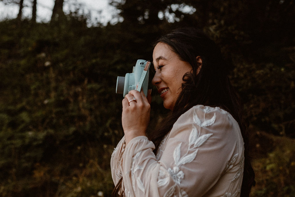 bride snaps a polaroid photo on her elopement day